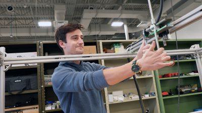 Ayden Cohn works in the lab of Yang Liu to adjust a device he built for measuring the size of water droplets in nuclear power applications. 